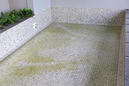 pool cleaning and maintenance: drained swimming pool before tile cleaning